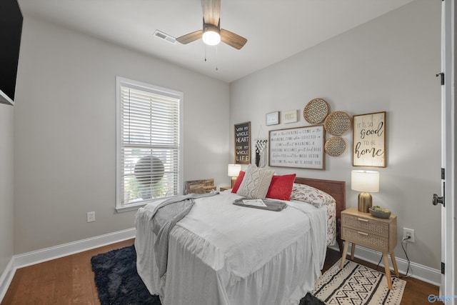 bedroom featuring visible vents, ceiling fan, wood finished floors, and baseboards