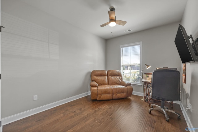 office featuring visible vents, a ceiling fan, dark wood finished floors, and baseboards
