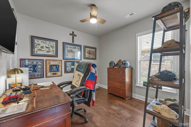 office space with baseboards, visible vents, wood finished floors, and a ceiling fan