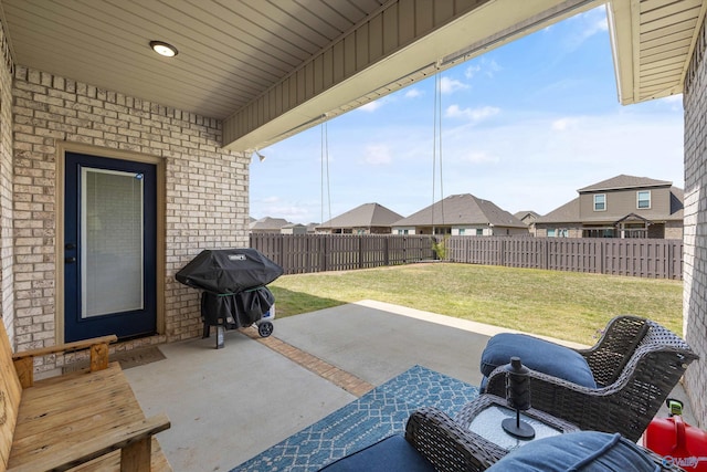 view of patio / terrace with a grill, a fenced backyard, and a residential view