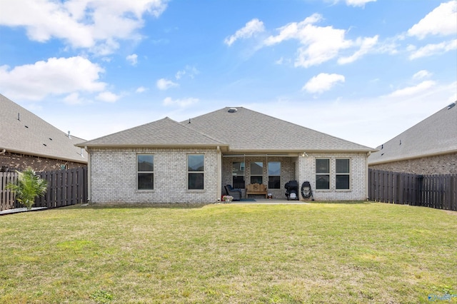 back of property with a patio area, brick siding, and a fenced backyard