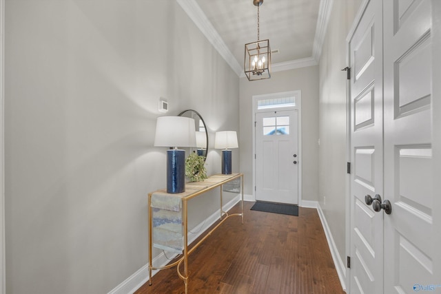 foyer with baseboards, ornamental molding, an inviting chandelier, and dark wood-style flooring
