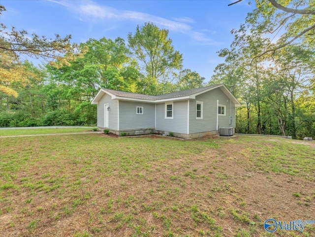 exterior space featuring a lawn and central AC unit