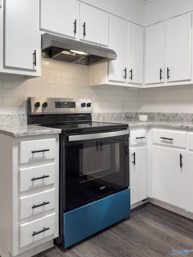 kitchen with white cabinets, light stone countertops, stainless steel electric range oven, tasteful backsplash, and dark hardwood / wood-style flooring