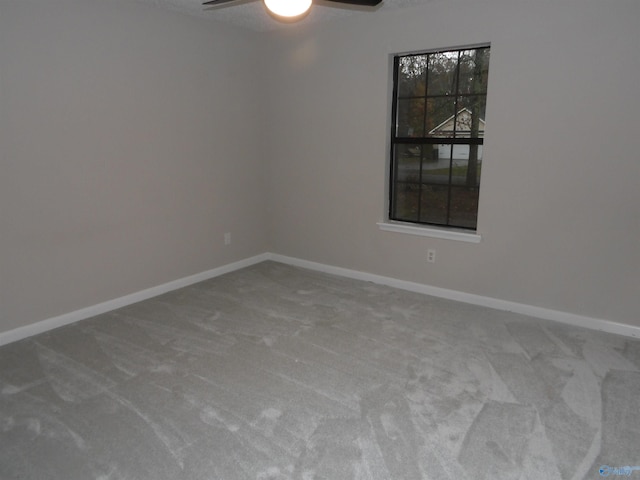 carpeted empty room featuring ceiling fan