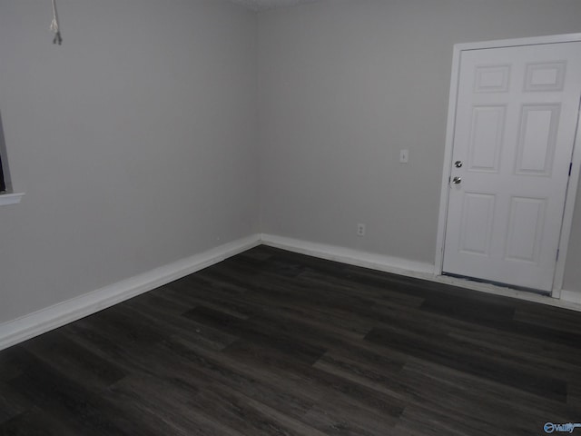 empty room featuring dark hardwood / wood-style flooring