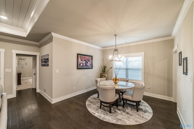 dining area with dark hardwood / wood-style floors, crown molding, and an inviting chandelier