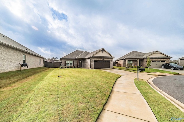 view of front of home with a front yard and a garage