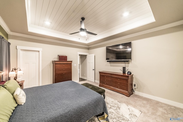 carpeted bedroom with ceiling fan, a raised ceiling, and crown molding