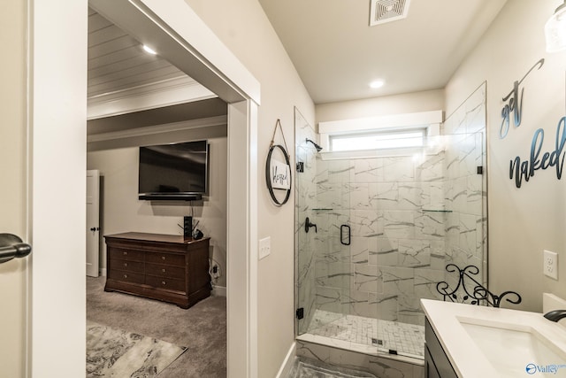 bathroom featuring vanity and a shower with door