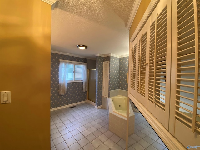 hallway with a textured ceiling, ornamental molding, and light tile patterned flooring