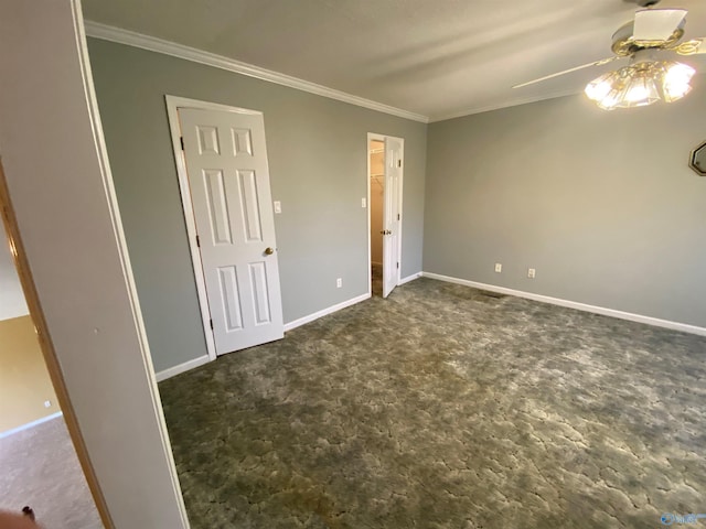 unfurnished room with ceiling fan and crown molding