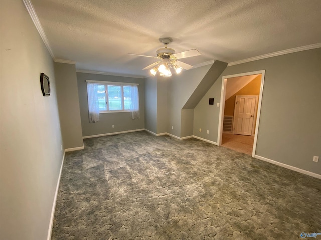 additional living space featuring ceiling fan, dark carpet, and a textured ceiling