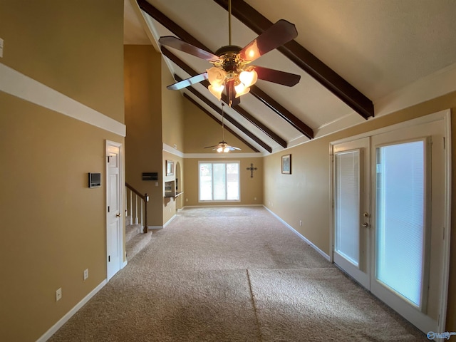 hall with beamed ceiling, light colored carpet, and high vaulted ceiling