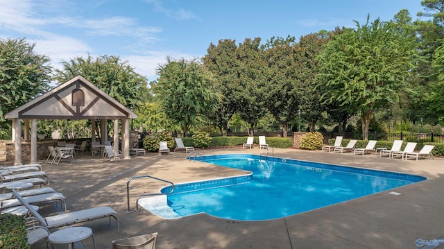 view of swimming pool with a gazebo and a patio area