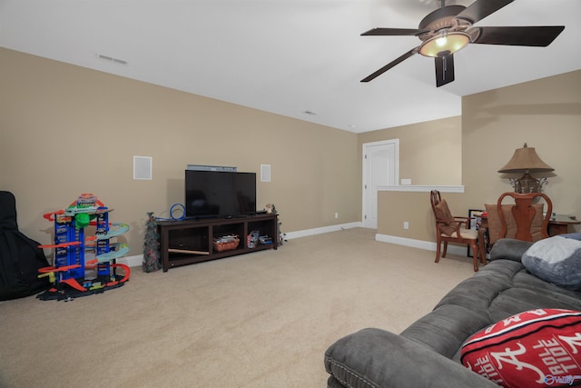 carpeted living room with ceiling fan