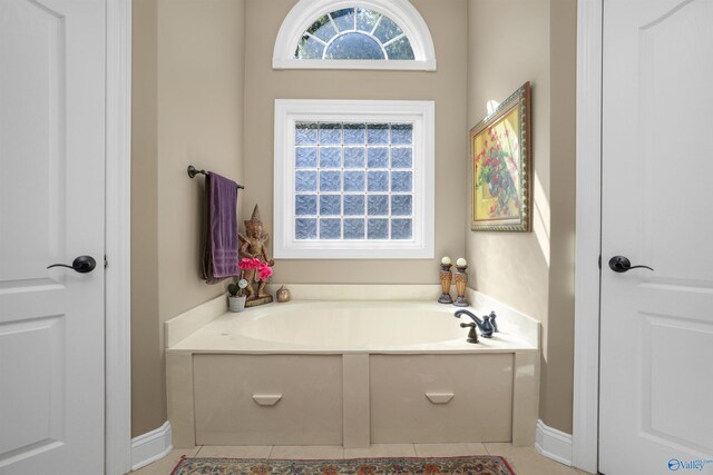 bathroom featuring tile patterned flooring and a tub