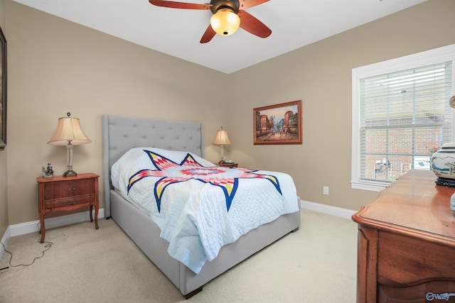 bedroom with ceiling fan and light colored carpet