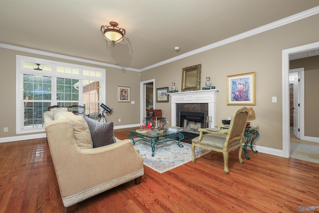 living room with hardwood / wood-style flooring, a fireplace, and crown molding