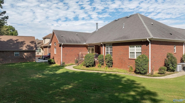 view of side of home featuring a lawn