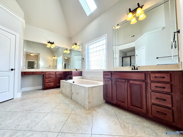 bathroom with tile patterned flooring, tiled tub, high vaulted ceiling, vanity, and a skylight