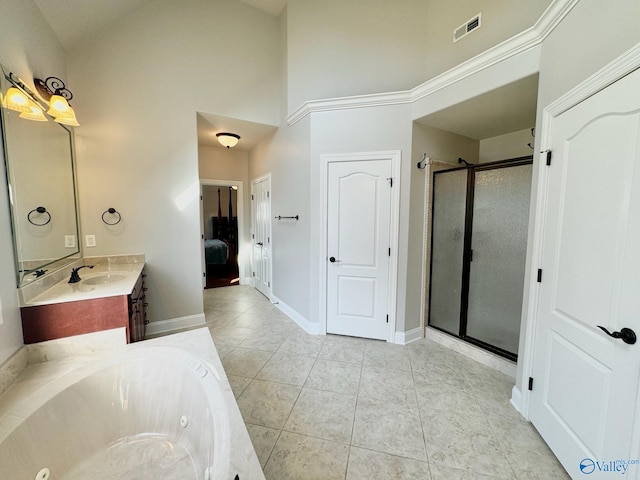 bathroom featuring tile patterned flooring, vanity, a high ceiling, and independent shower and bath