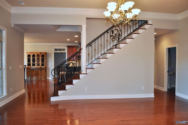 stairway featuring hardwood / wood-style flooring, a chandelier, and crown molding