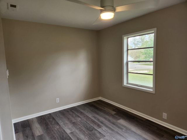 unfurnished room featuring dark wood-type flooring and ceiling fan