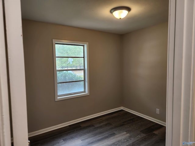 spare room featuring dark hardwood / wood-style flooring