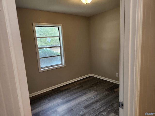 empty room featuring dark wood-type flooring