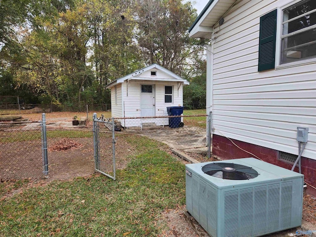 view of yard featuring central AC unit and an outbuilding