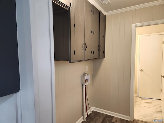 laundry room with wood walls, washer hookup, ornamental molding, and dark hardwood / wood-style floors