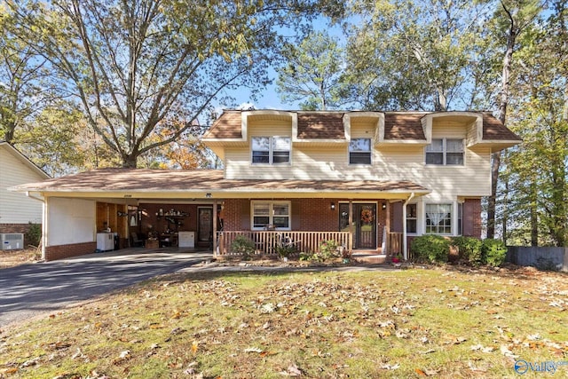 view of front of home with a front yard, a porch, central AC unit, and a carport