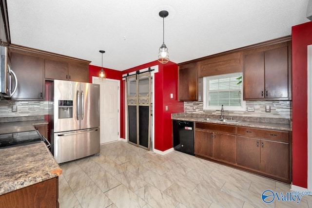204 Hollington Dr, Huntsville, AL 35811 - kitchen featuring appliances with stainless steel finishes, a barn door, decorative backsplash, pendant lighting, and dark brown cabinets