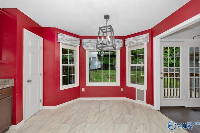 204 Hollington Dr, Huntsville, AL 35811 - unfurnished dining area with a chandelier and baseboards