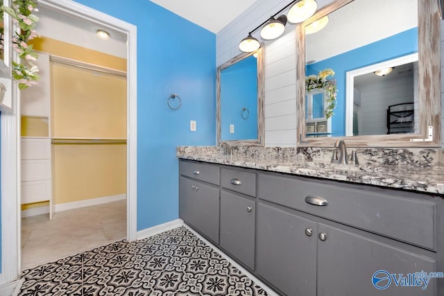 204 Hollington Dr, Huntsville, AL 35811 - bathroom featuring double vanity, tile patterned floors, and a walk in closet