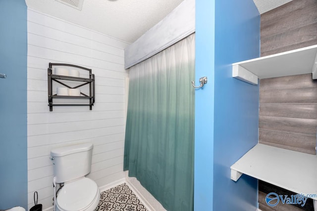 204 Hollington Dr, Huntsville, AL 35811 - bathroom with wood walls, a textured ceiling, and a shower with curtain