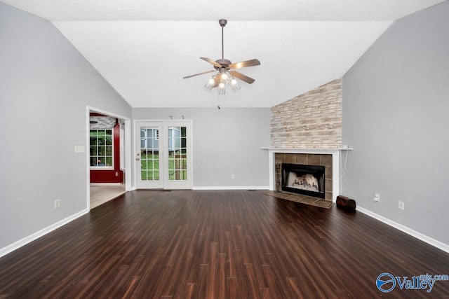 204 Hollington Dr, Huntsville, AL 35811 - unfurnished living room with ceiling fan, a tiled fireplace, wood finished floors, and high vaulted ceiling