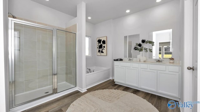 bathroom with separate shower and tub, hardwood / wood-style floors, and vanity