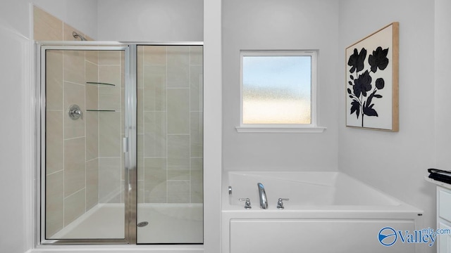 bathroom featuring separate shower and tub