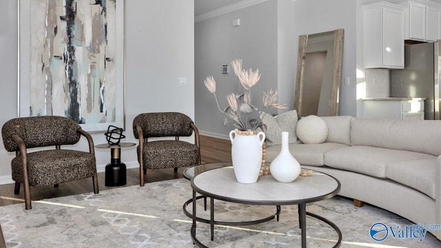 living room featuring wood-type flooring and ornamental molding