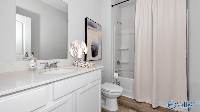 full bathroom with vanity, toilet, shower / bathtub combination with curtain, and hardwood / wood-style flooring