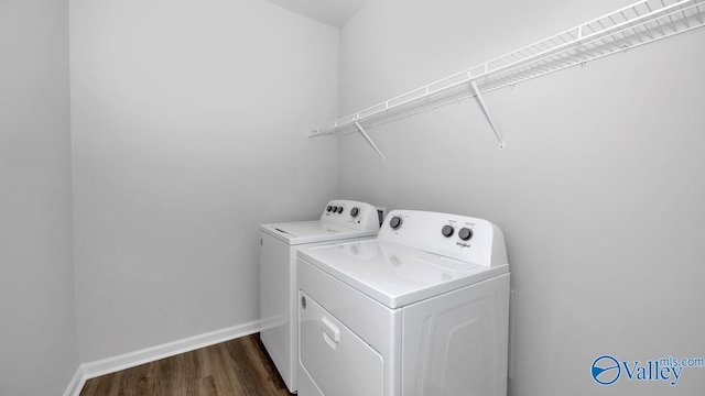 laundry area featuring washer and dryer and dark wood-type flooring