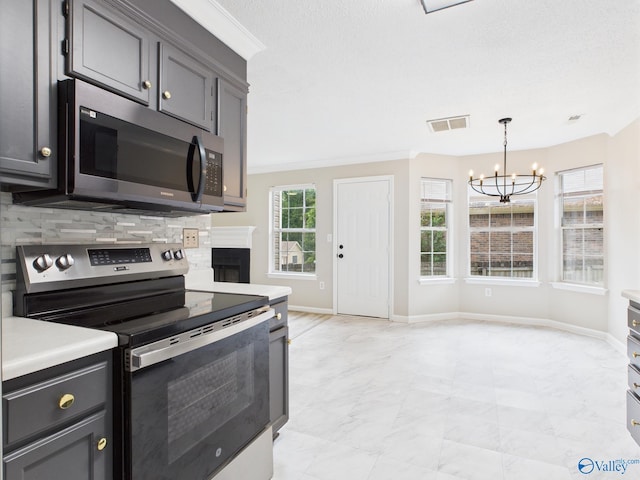 202 Declaration Cir, Madison, AL 35758 - kitchen featuring appliances with stainless steel finishes, a chandelier, backsplash, light countertops, and crown molding