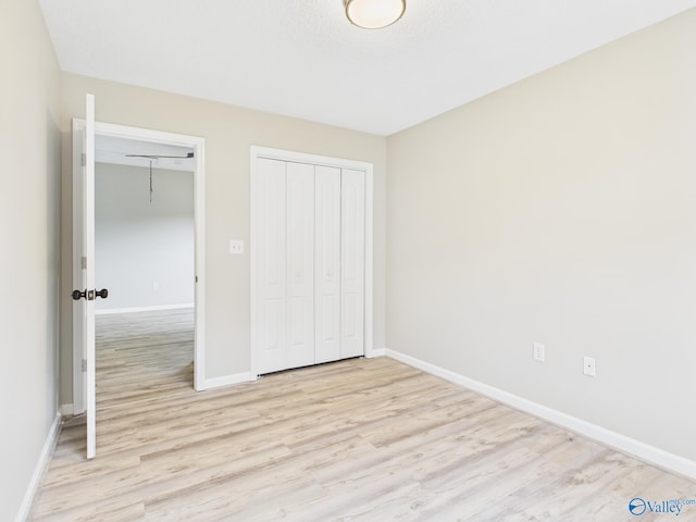 202 Declaration Cir, Madison, AL 35758 - unfurnished bedroom with light wood finished floors and a closet