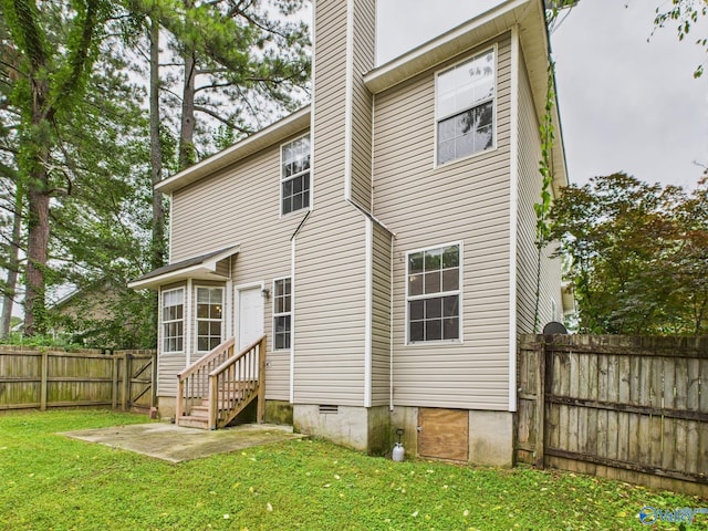 202 Declaration Cir, Madison, AL 35758 - back of house with entry steps, a fenced backyard, a chimney, and a patio area