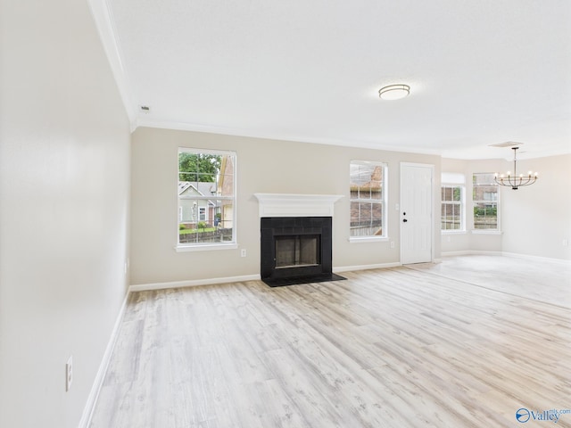202 Declaration Cir, Madison, AL 35758 - unfurnished living room with a chandelier, ornamental molding, light wood-type flooring, and a fireplace with flush hearth