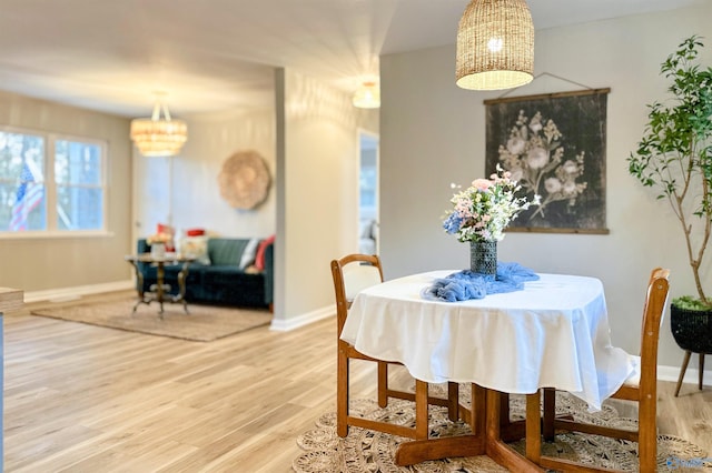 dining space featuring wood finished floors and baseboards