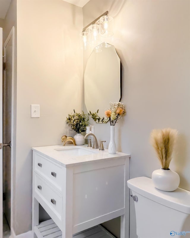 bathroom featuring toilet and vanity