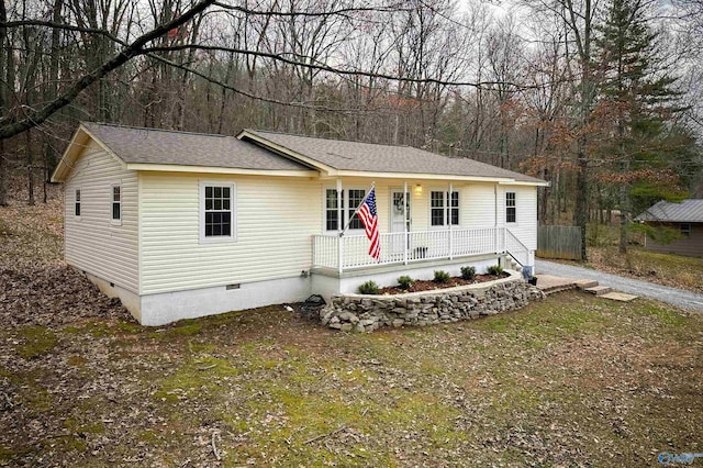 view of front of property featuring a porch, roof with shingles, and crawl space